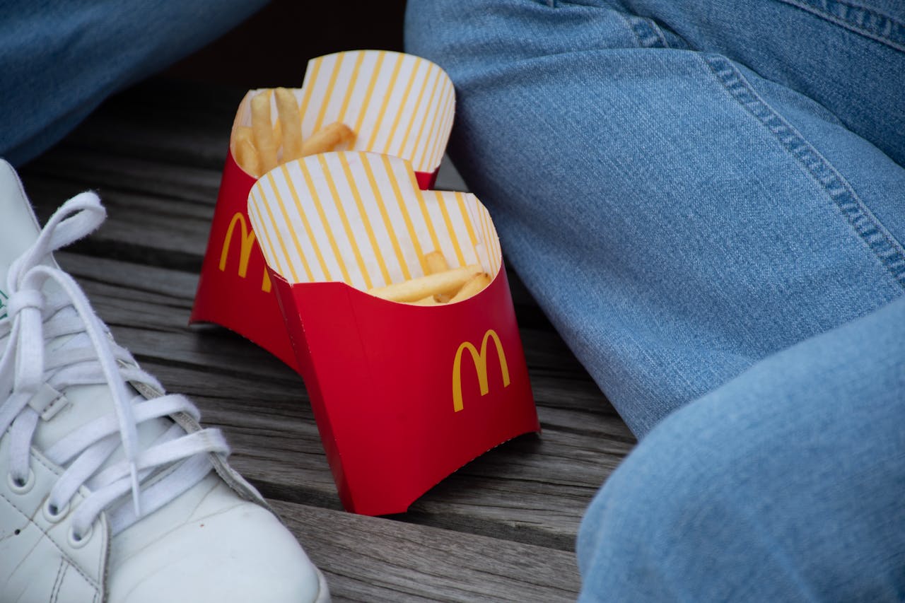 person sat with mcdonalds fries