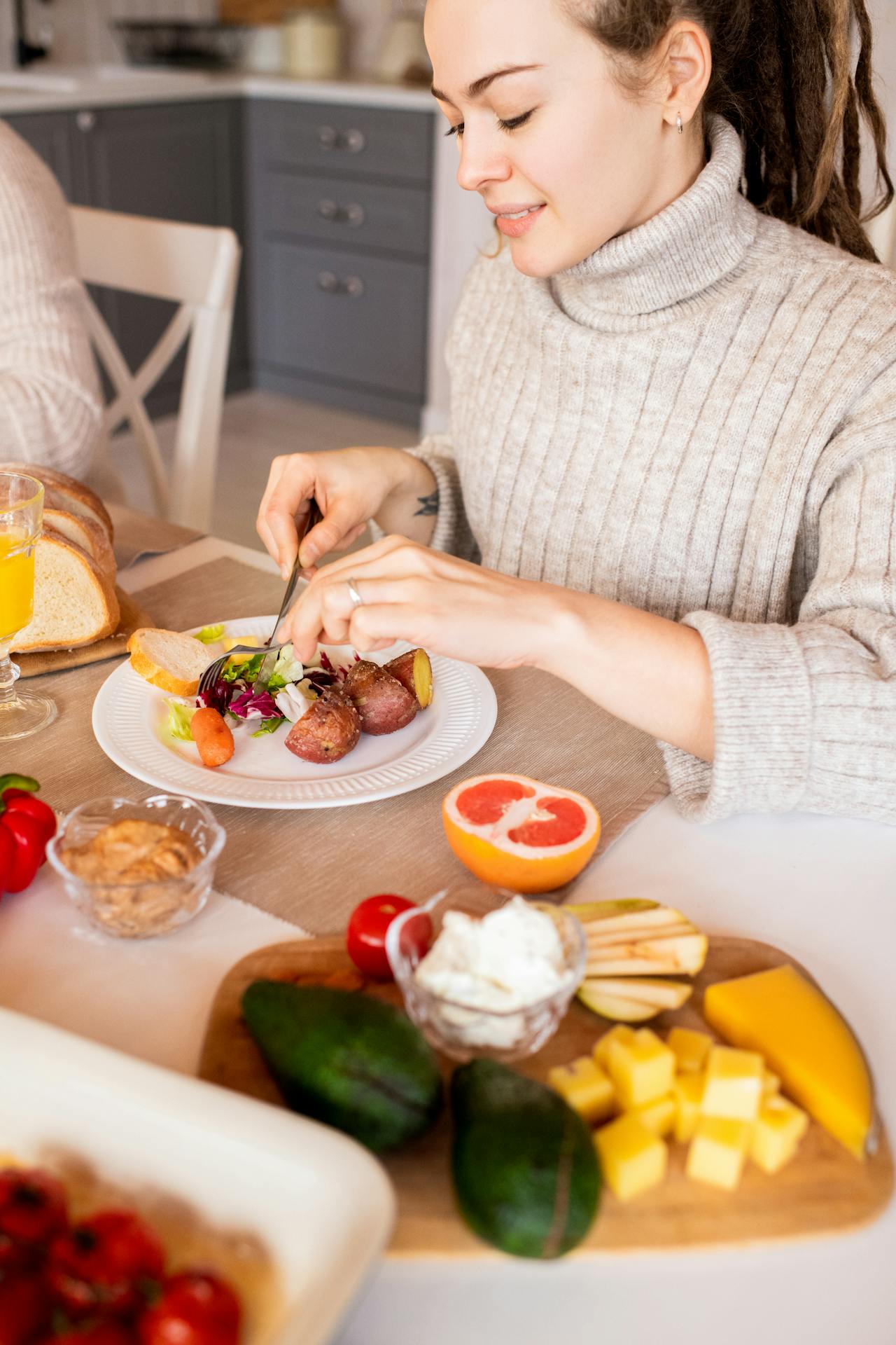 woman eating plate of vegetables